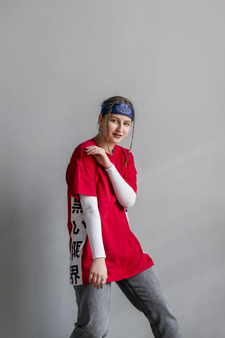 portrait-female-dancer-against-grey-wall-looking-camera